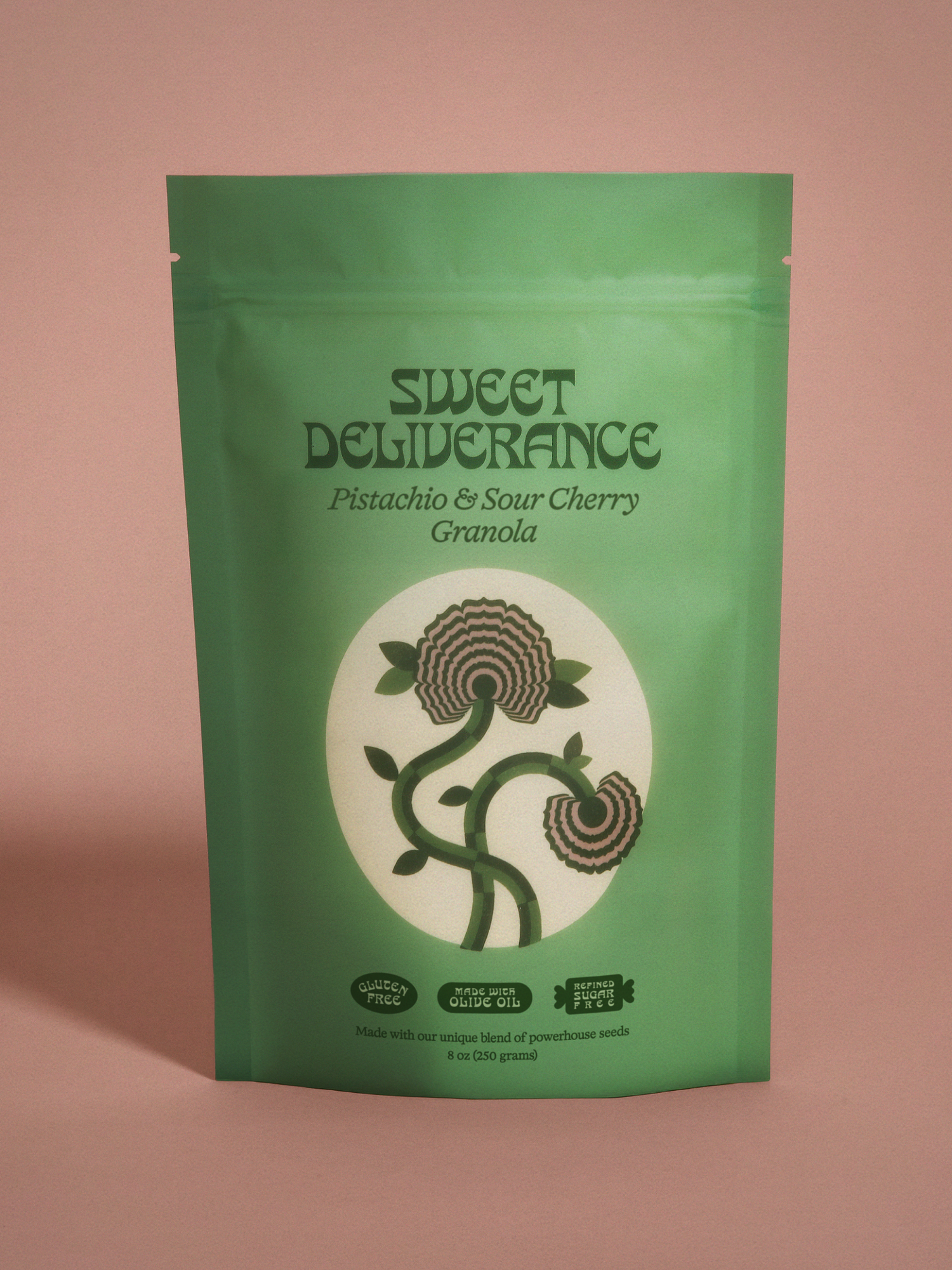 Sour Cherry and Pistachio Rose granola by Sweet Deliverance, 8oz bag on pink background.